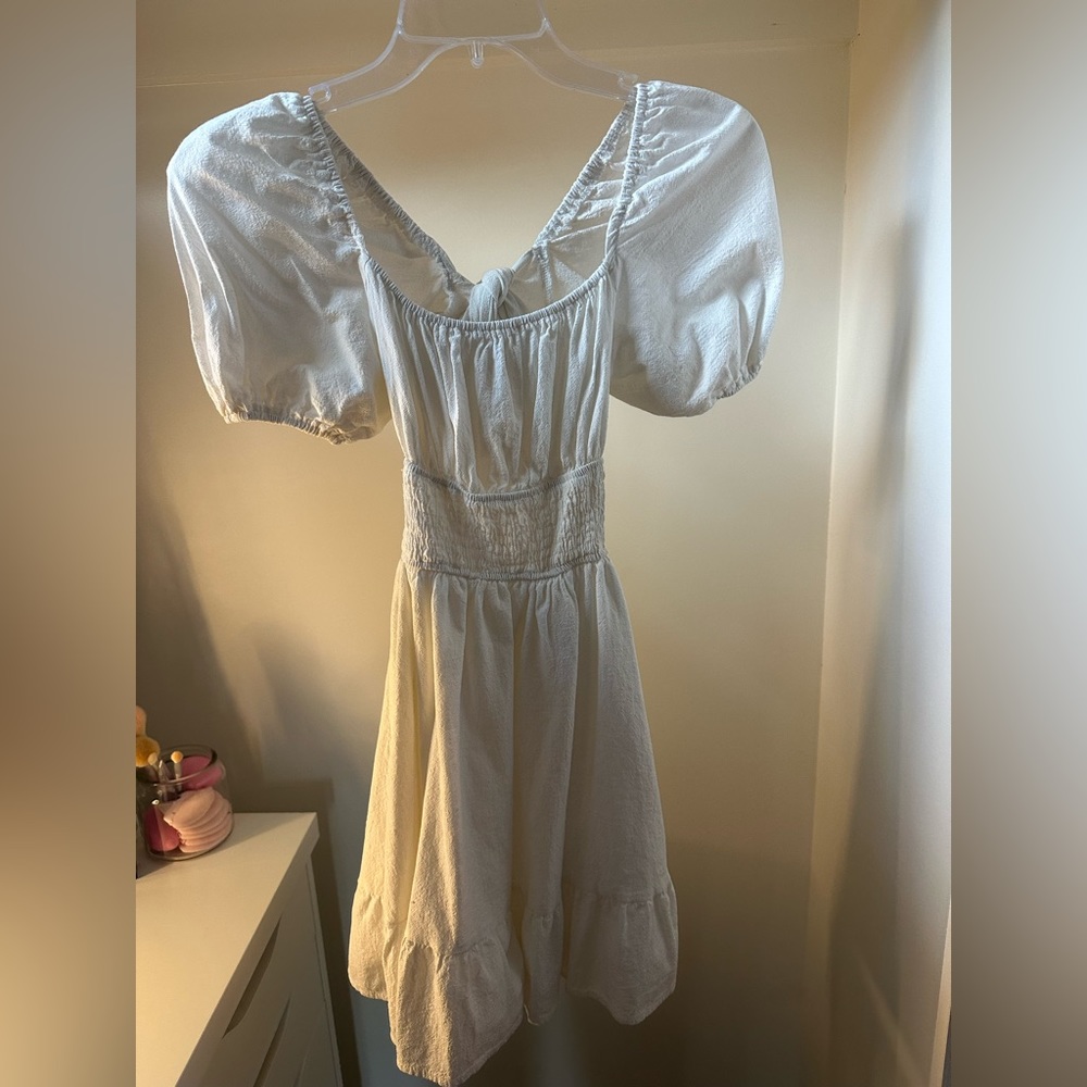 Plain white dress, cute bow in the back, puffy sleeves!